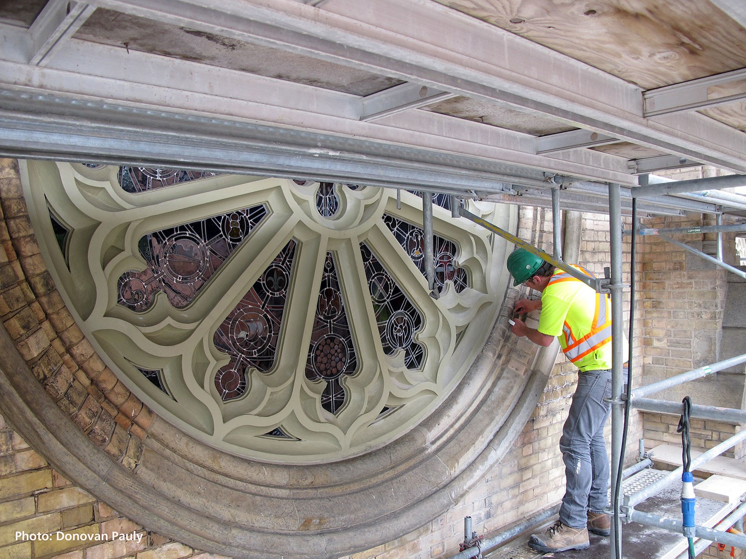 Man undertaking conservation cleaning of a heritage window (Photo: Donovan Pauly)