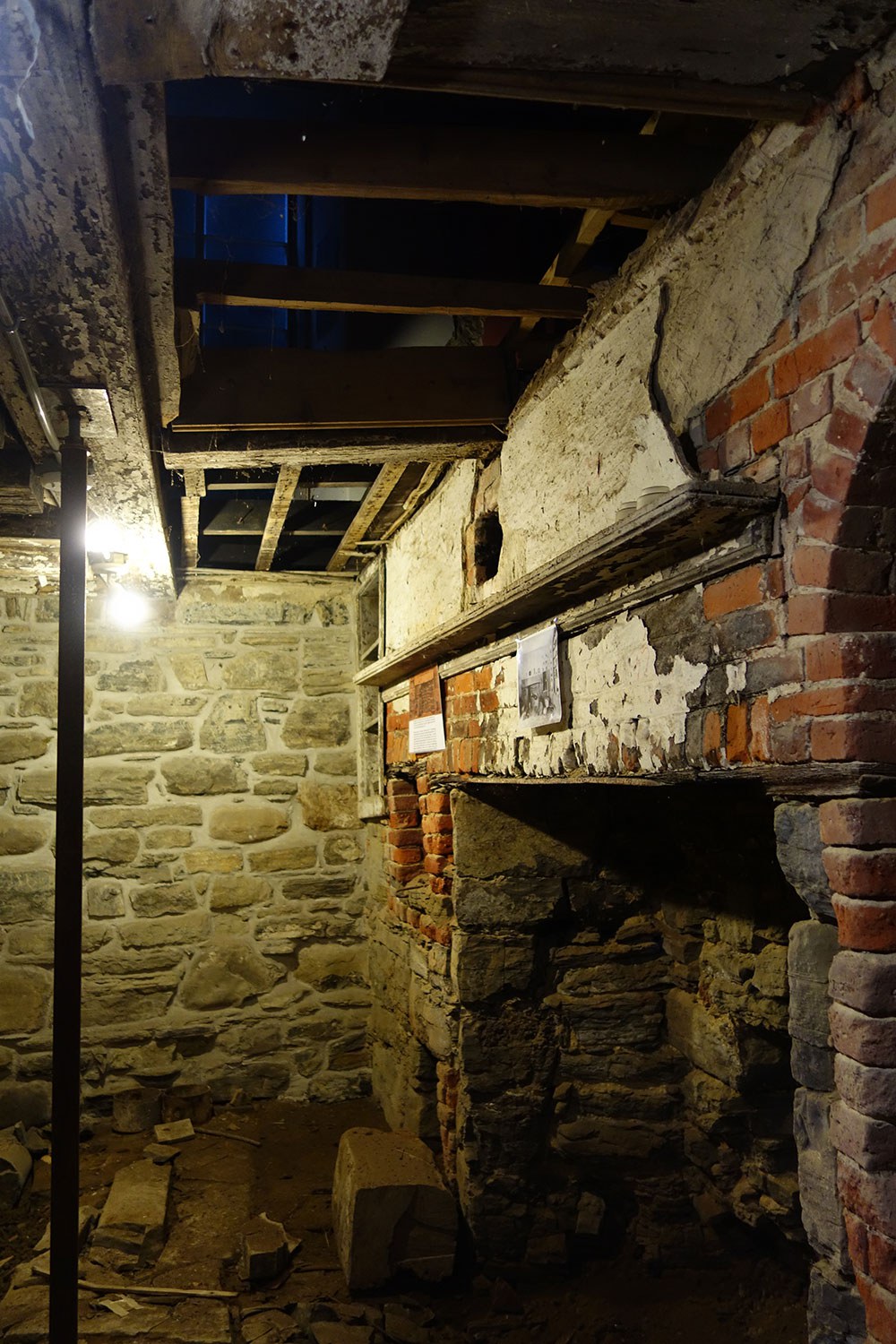 The basement bake-oven and open hearth, preserved as an architectural ruin