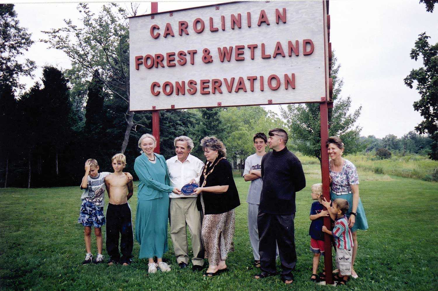 Willem Hanrath, with his children and grandchildren, being presented with an Ontario Heritage Trust easement marker to recognize their generous donation of the natural heritage easement for the Caistor-Canborough Slough Forest ANSI (47 acres/19 hectares)