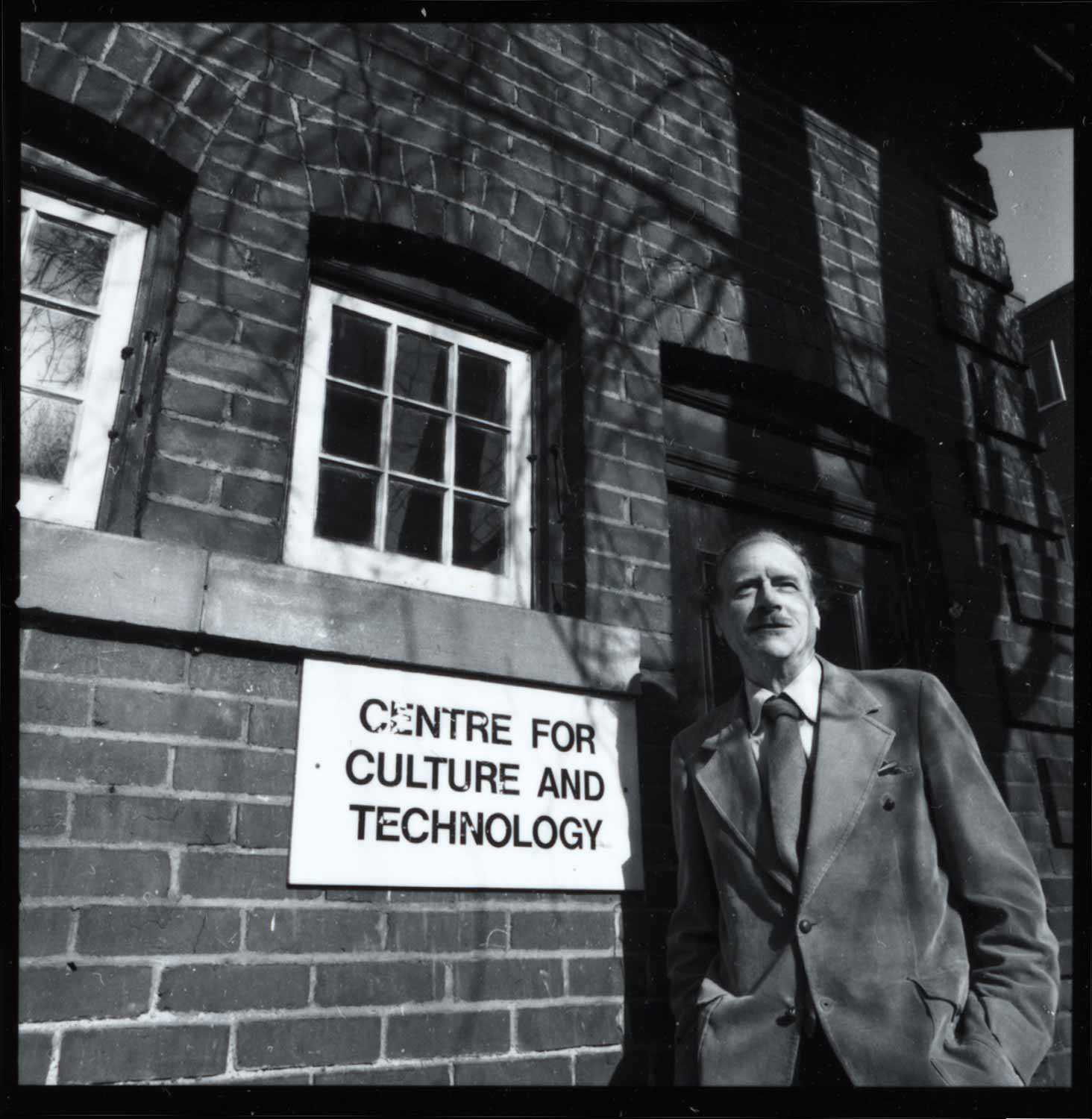 McLuhan in front of coach house at the University of Toronto.