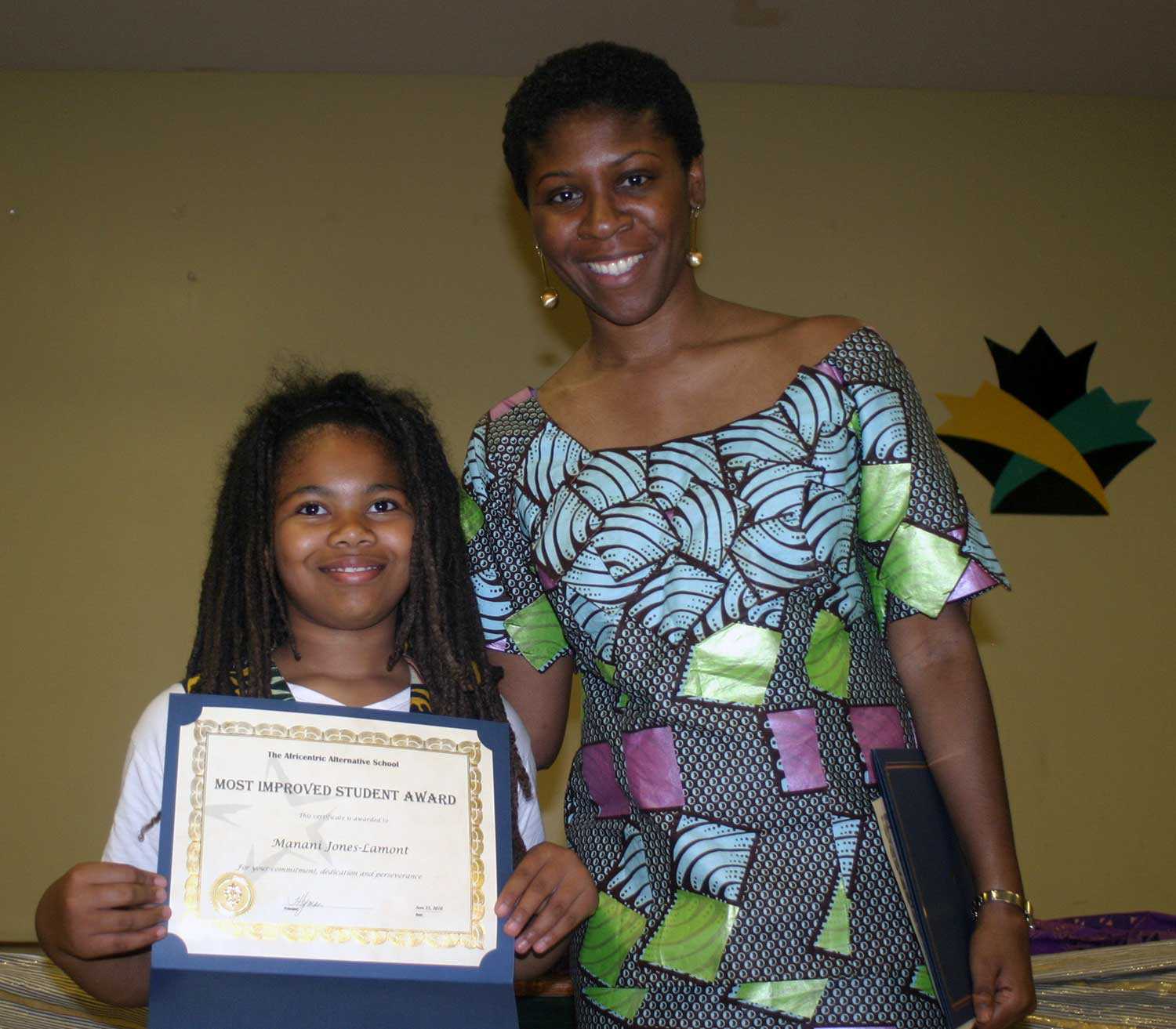 Former student Manani Jones (left) received the Most improved student award from Principal Hyman at the inaugural AAS gala in June 2010. Photo: Africentric Alternative School