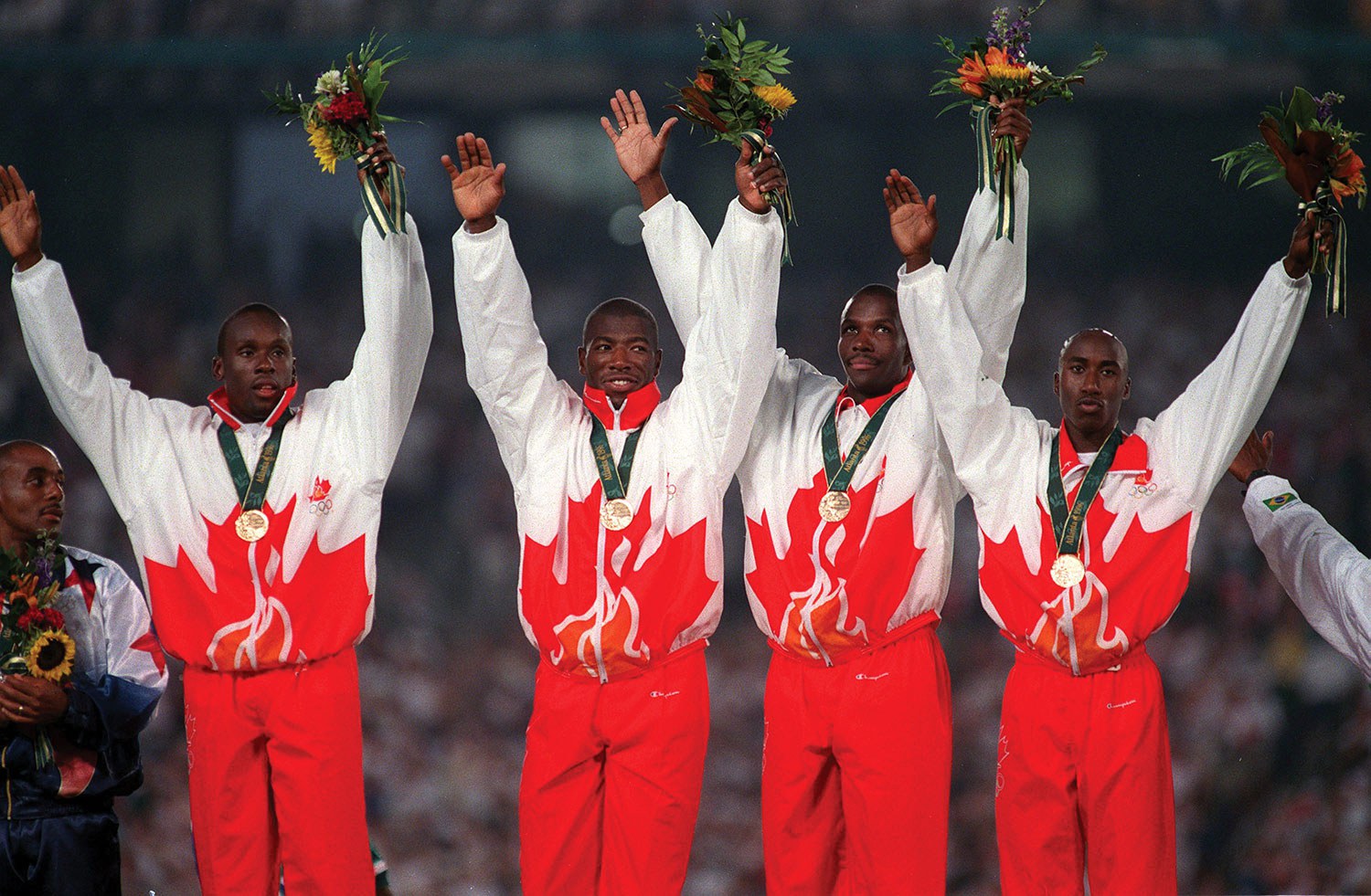 Men’s 4 x 100-metre relay gold medal ceremony, 1996 (Bruny Surin, Glenroy Gilbert, Donovan Bailey and Robert Esmie). Photo courtesy of the Canadian Olympic Committee