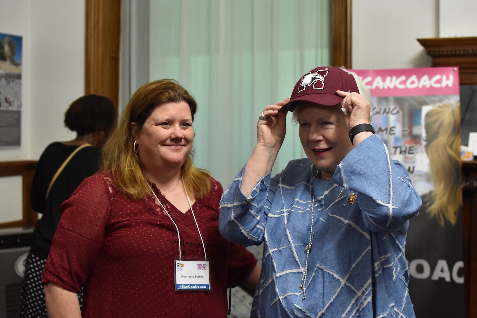 The Lieutenant Governor and Stephanie Sutton, a softball coach at McMaster University and coach mentor, share a light moment.