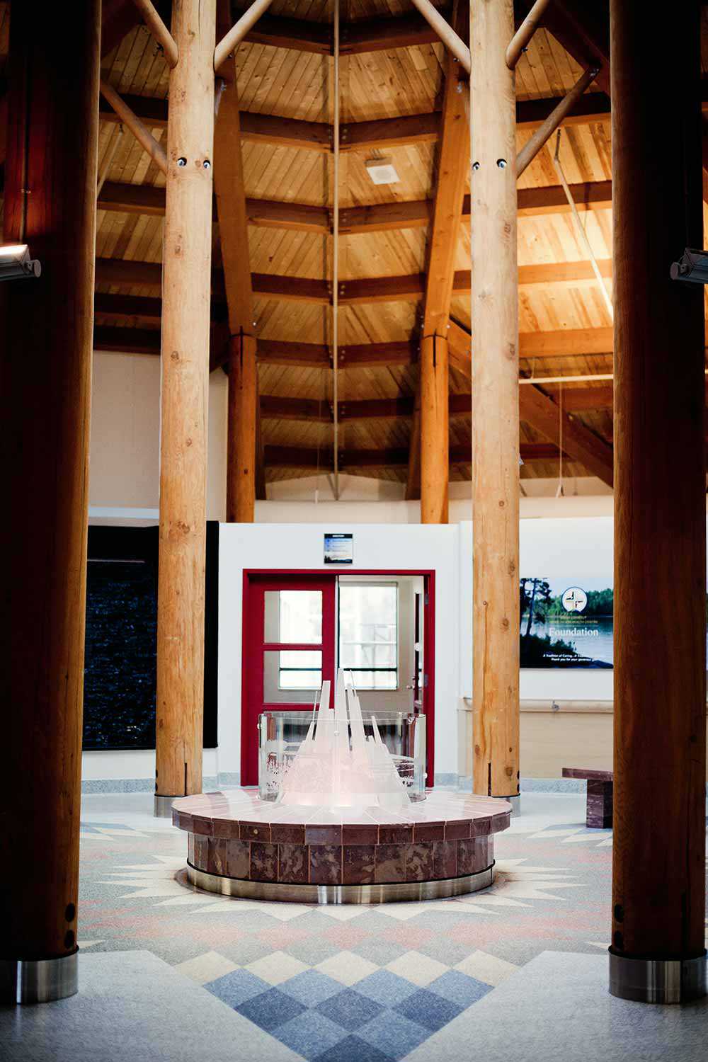 The Gathering Area in the Sioux Lookout Meno Ya Win Health Centre (SLMHC) is designed to suggest a clearing in a forest, a lodge or longhouse, with a fireplace that symbolizes unity with the community. Photo used with permission of the SLMHC.