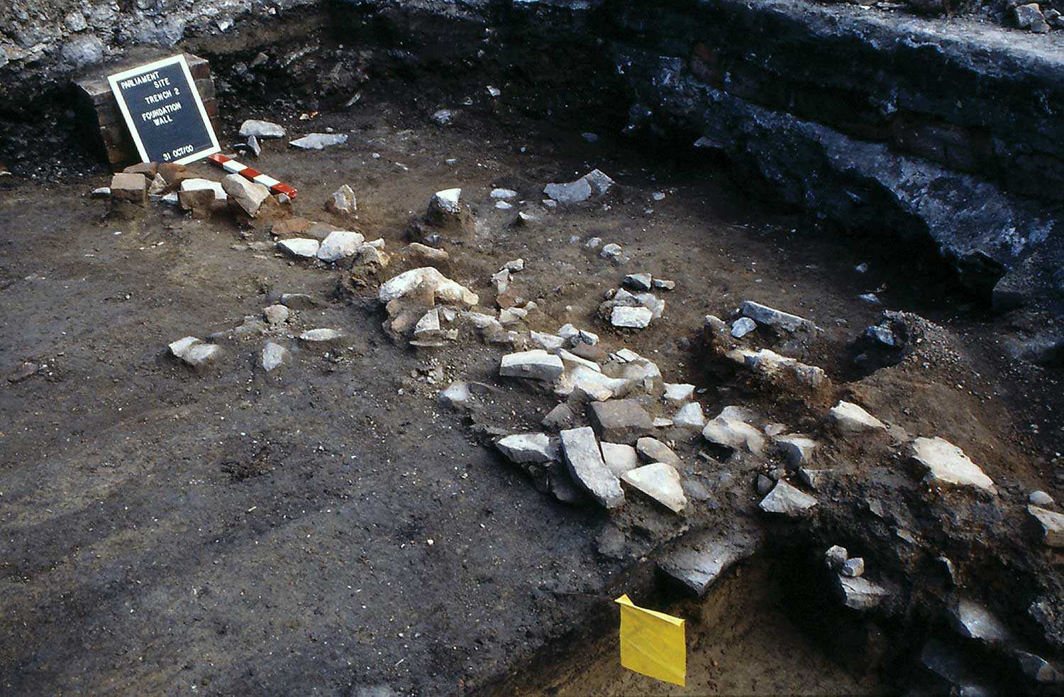 Charred floor joists extending into the stone footing